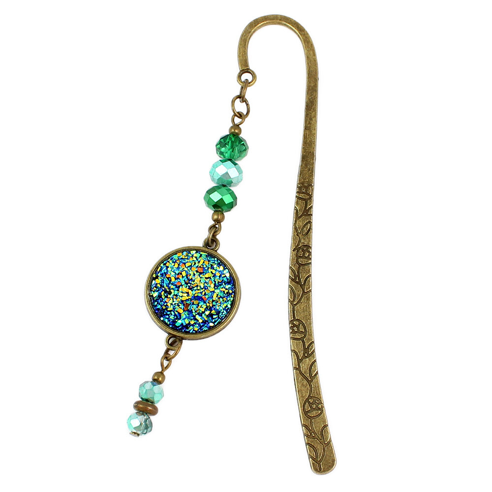 Zakładka do książki mieniąca druza z żywicy kryształki Zakładka do książki z antycznego brązu z motywem roślinnym, zielonymi kryształkami i mieniącą się, błyszczącą druzą z żywicy