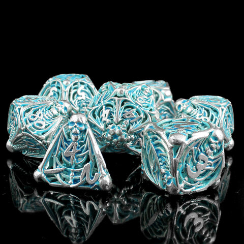 Metalowe ażurowe kości RPG ze szkieletami świecące na błękitno w ciemności | Kości RPG Frostbound Souls Lume Design