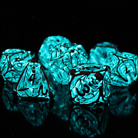 Metalowe ażurowe kości RPG ze szkieletami świecące na błękitno w ciemności | Kości RPG Frostbound Souls Lume Design